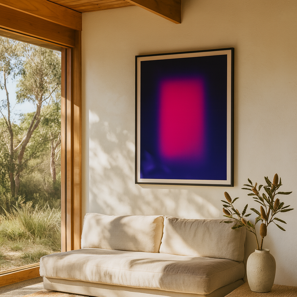 Living room with a beige sofa, abstract art on the wall, and a vase with plants.